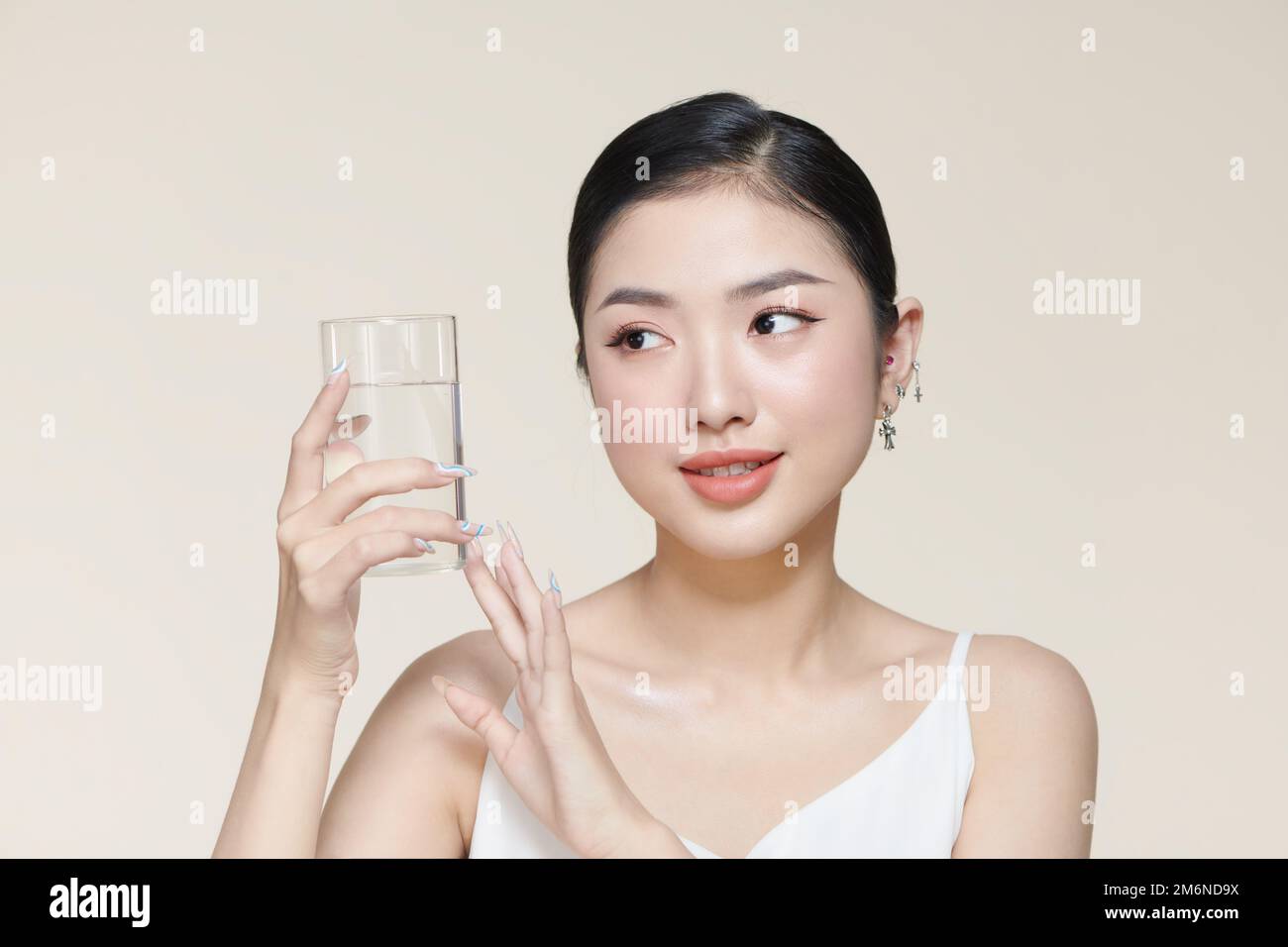 pretty young woman drinking water from glass Stock Photo