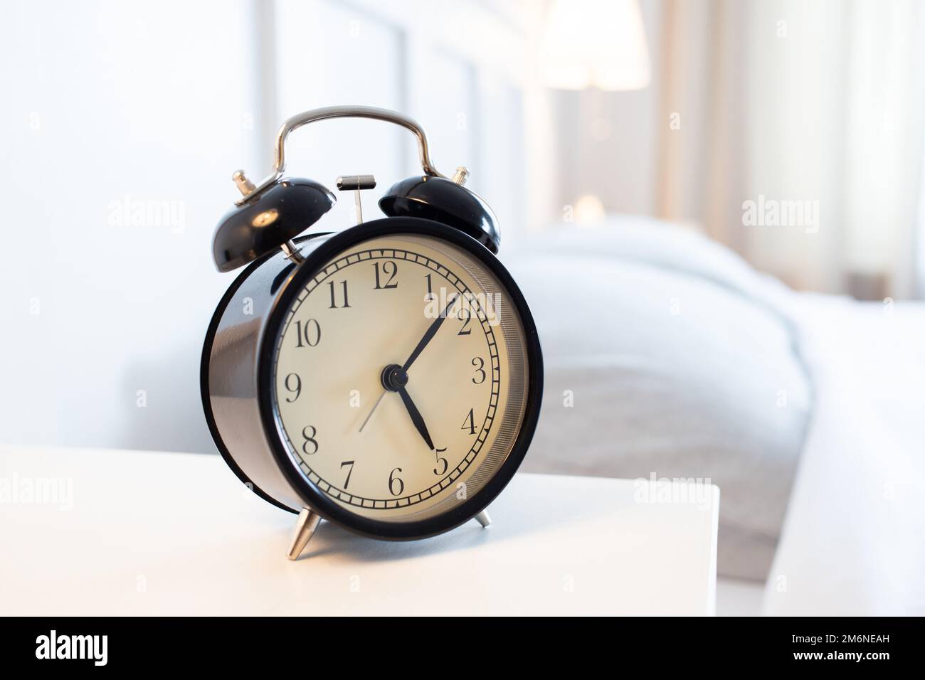 Vintage alarm clock in bright bedroom Stock Photo Alamy