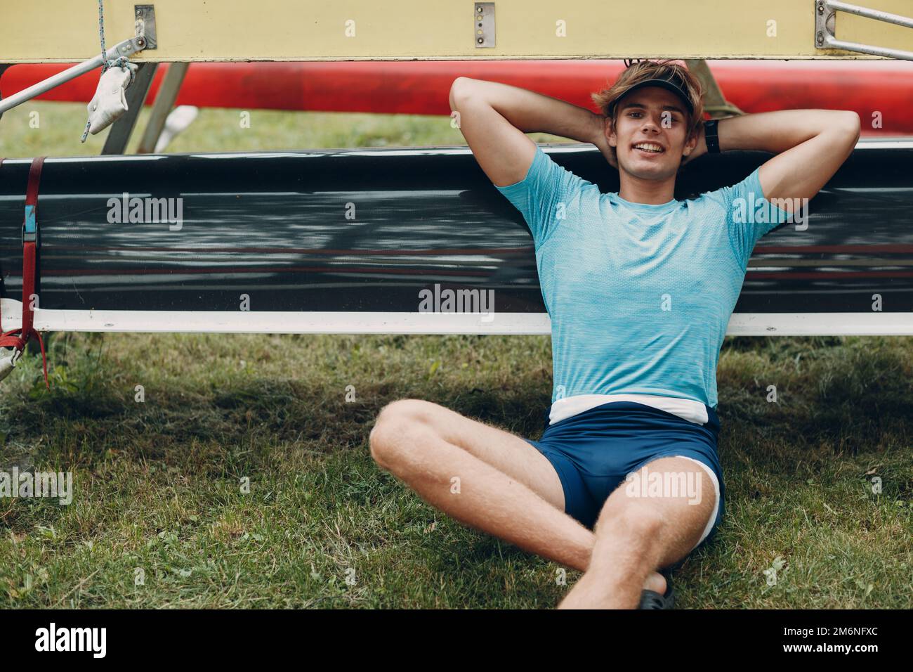 Sportsman single scull man rower prepare to competition with boat. Olympic games sport. Stock Photo