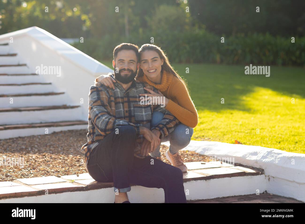 Image of happy caucasian couple posing in autumn garden Stock Photo - Alamy