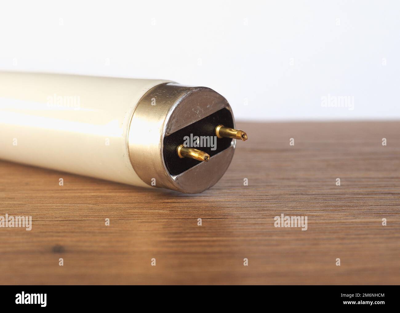 fluorescent tube light bulb over wooden desktop Stock Photo Alamy