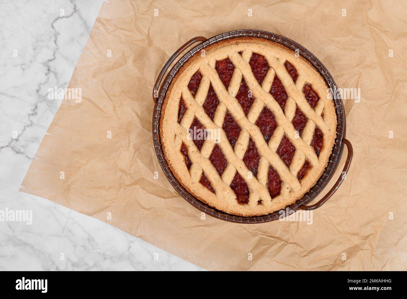 Pie called 'Linzer Torte', a traditional Austrian shortcake pastry topped with fruit preserves and nuts with lattice design Stock Photo