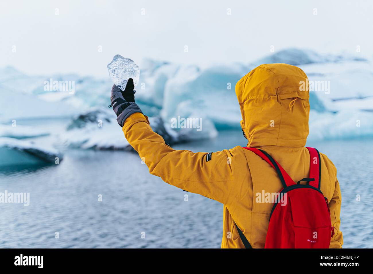 woman with glacier iceberg in hand Stock Photo