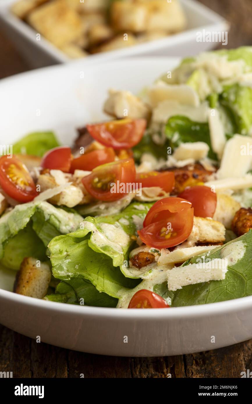 Caesar salad on dark wood Stock Photo