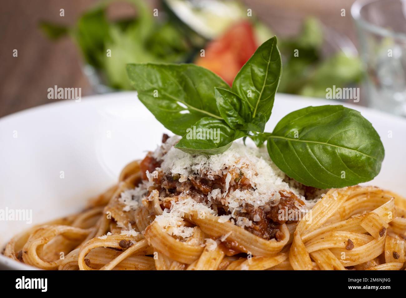 Tagliatelli pasta with bolognaise sauce on wood Stock Photo