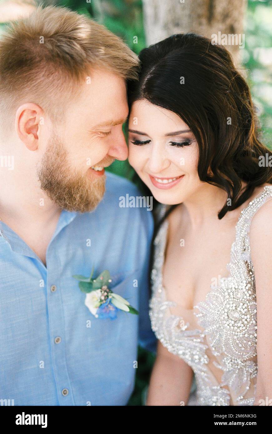Bride and groom touch their foreheads to each other. Portrait Stock Photo