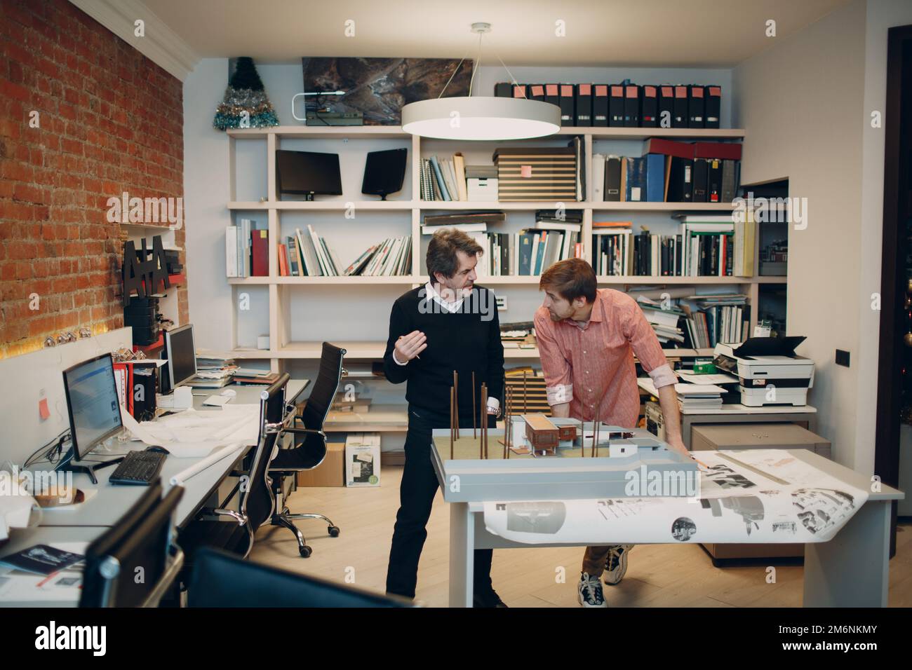 Architect with blueprints and layout design project at office Stock Photo