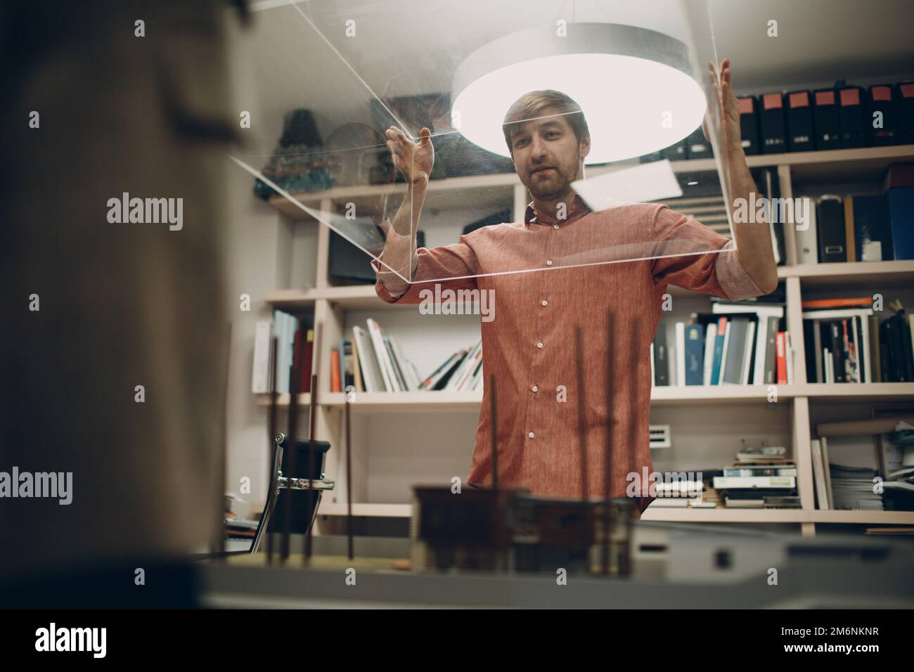 Architect with blueprints and layout design project at office Stock Photo