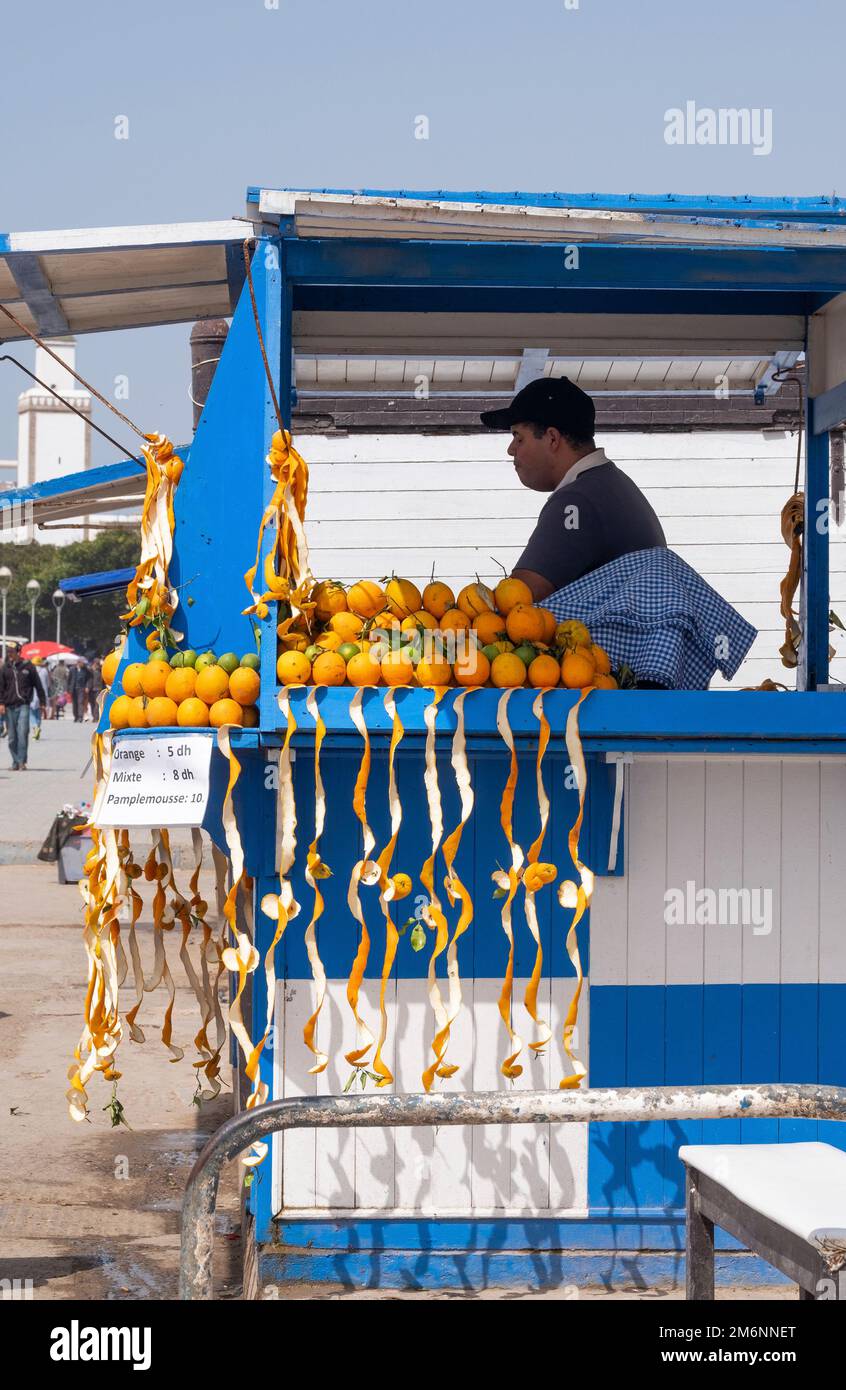 Salesman of squeezed orange juice on the port of Essaouira Stock Photo
