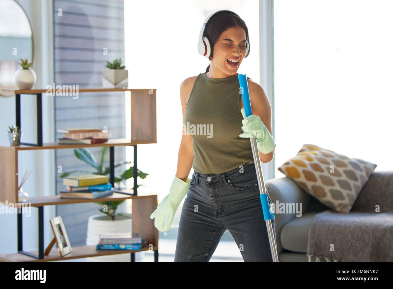 Cleaning, singing and black woman listening to music for fun, energy