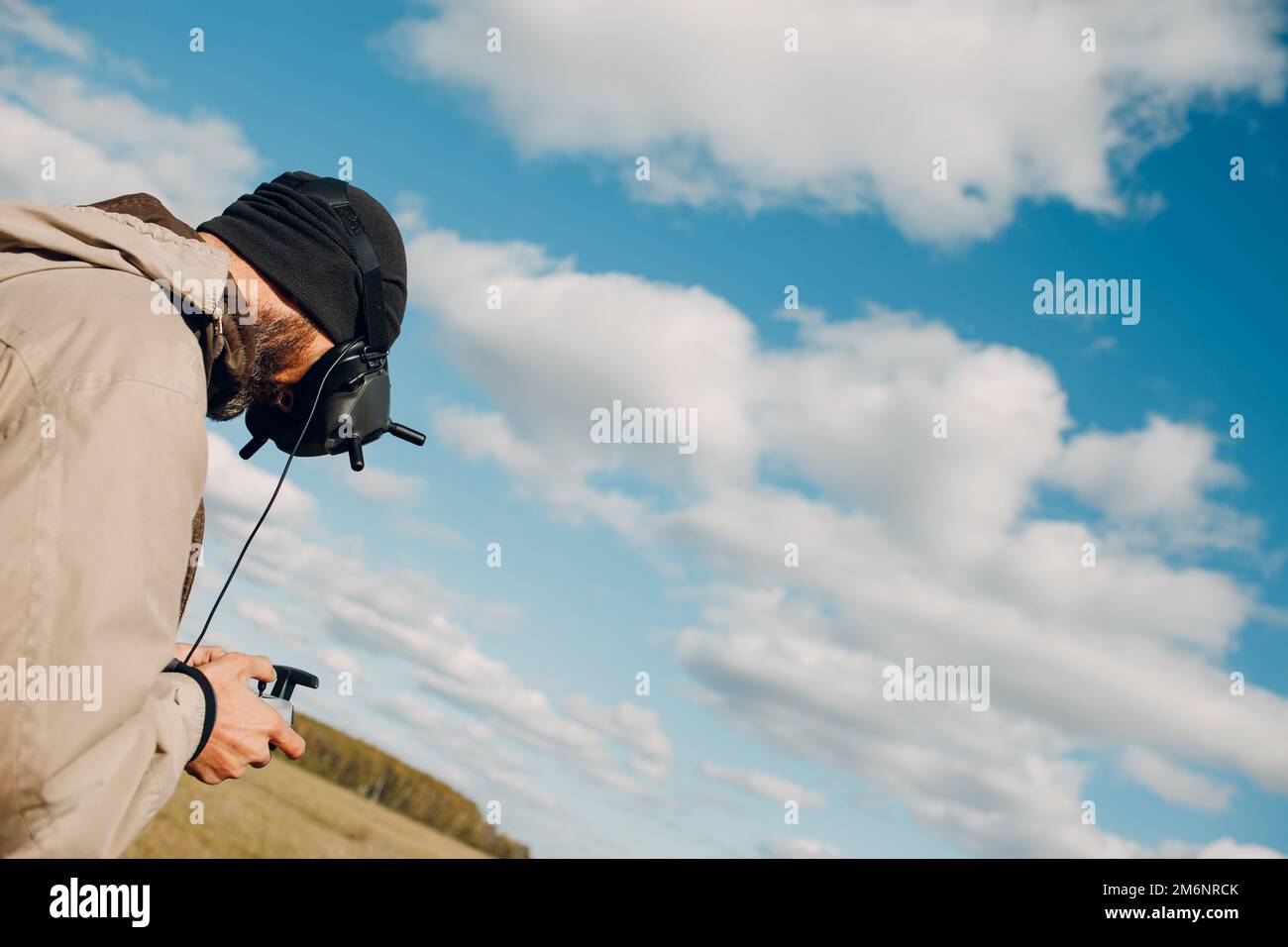 Man controlling fpv quadcopter drone with goggles antenna remote ...