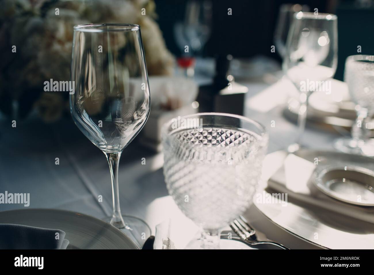 Beautiful shape empty wine glass on table in restaurant decor Stock Photo