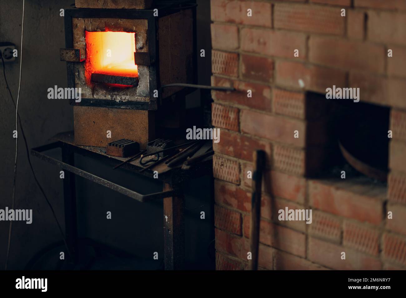 Blacksmith oven with hot flame. Smith heating iron piece of steel
