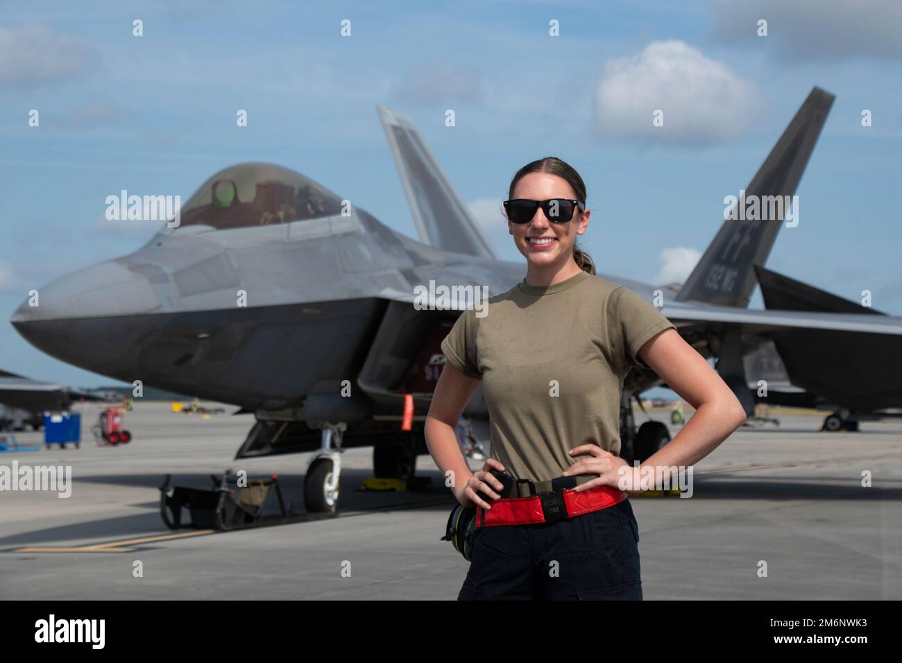 U.S. Air Force Airman 1st Class Kristina Lorelli, a crew chief with the 192nd Aircraft Maintenance Squadron, Virginia Air National Guard, poses for a photo in front of an F-22 Raptor May 3, 2022, at the Air Dominance Center, a Combat Readiness Training Center, in Savannah, Georgia. Sentry Savannah 2022 is the Air National Guard’s premier counter air exercise, encompassing 10 units of fourth and fifth generation fighter aircraft, which tests the capabilities of our warfighters in a simulated near-peer environment and trains the next generation of fighter pilots for tomorrow’s fight. Stock Photo