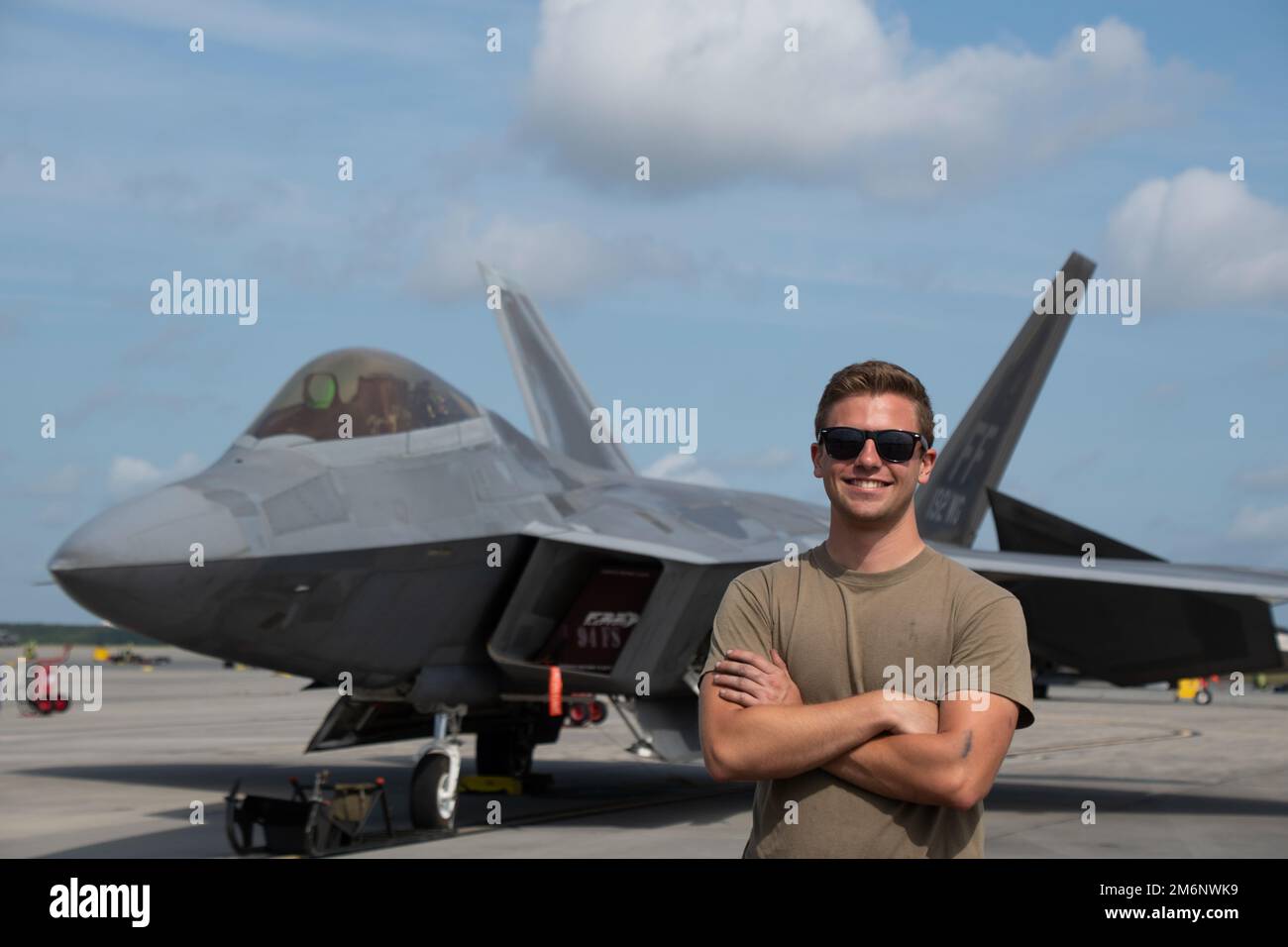U.S. Air Force Airman 1st Class Adam Sickels, a crew chief with the 192nd Aircraft Maintenance Squadron, Virginia Air National Guard, poses for a photo in front of an F-22 Raptor May 3, 2022, at the Air Dominance Center, a Combat Readiness Training Center, in Savannah, Georgia. Sentry Savannah 2022 is the Air National Guard’s premier counter air exercise, encompassing 10 units of fourth and fifth generation fighter aircraft, which tests the capabilities of our warfighters in a simulated near-peer environment and trains the next generation of fighter pilots for tomorrow’s fight. Stock Photo