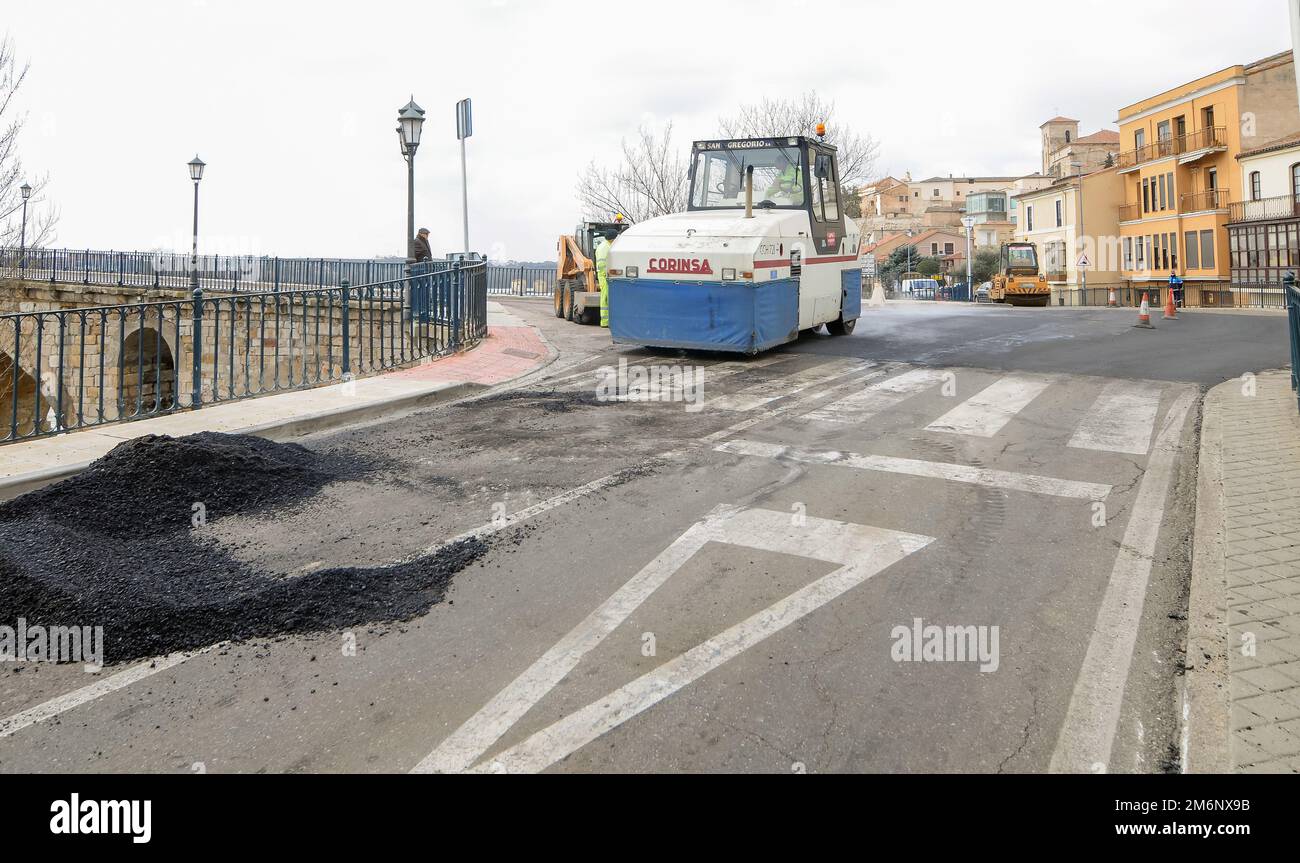 Machines performing asphalting and paving work on a city road. Stock Photo