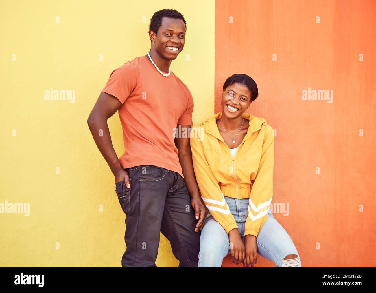 Black couple, smile and urban portrait by wall with edgy fashion, happy and bonding with color. Gen z, happy couple and city wall background with Stock Photo