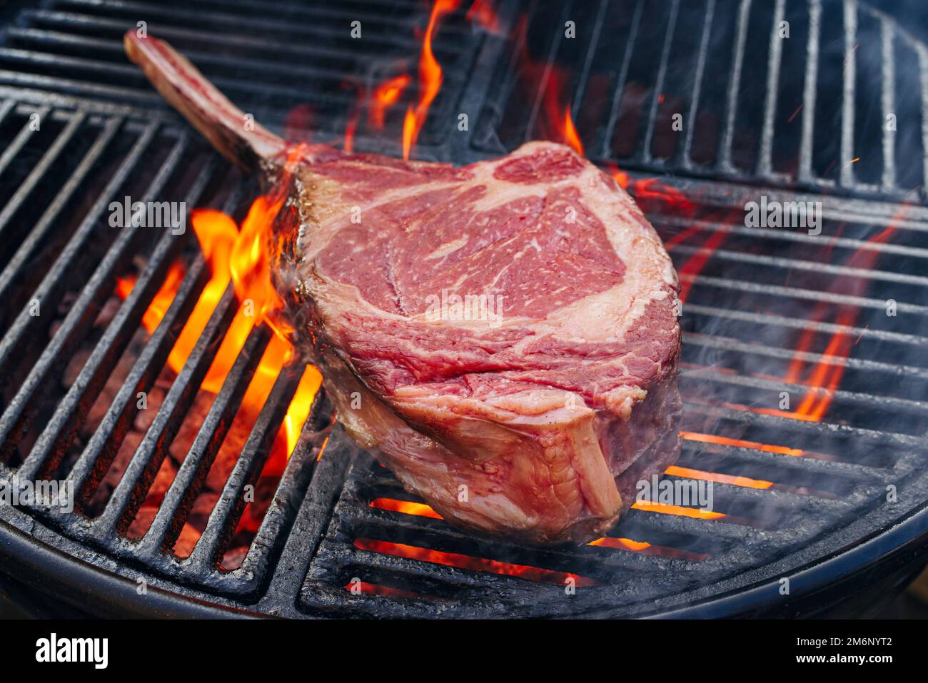 Barbecue dry aged wagyu tomahawk steak offered as closeup on a