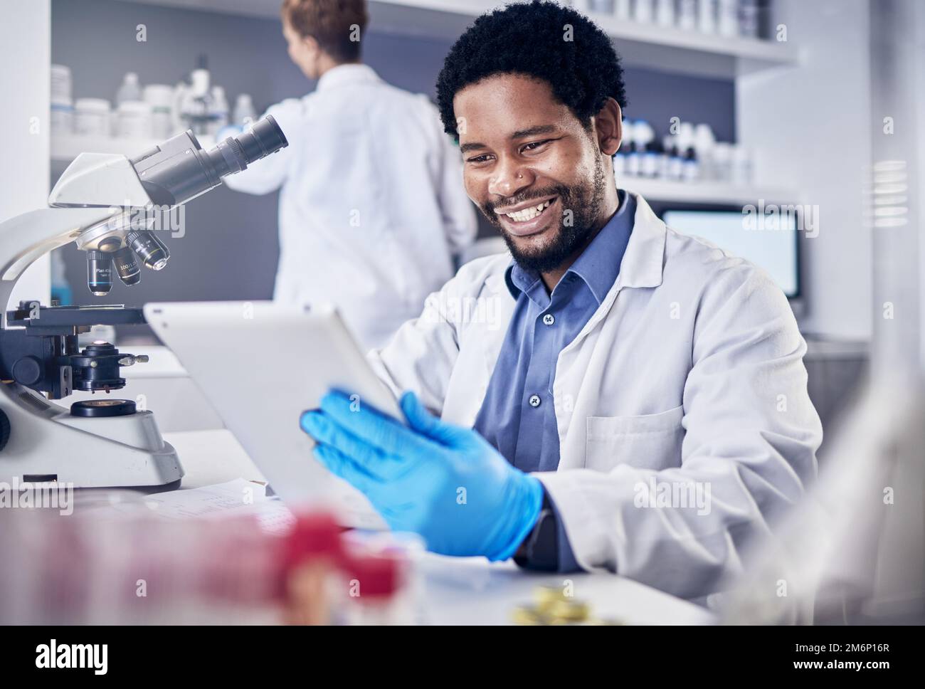 Scientist, research and black man with tablet, laboratory and innovation for healthcare, online schedule or tech. African American male, researcher Stock Photo