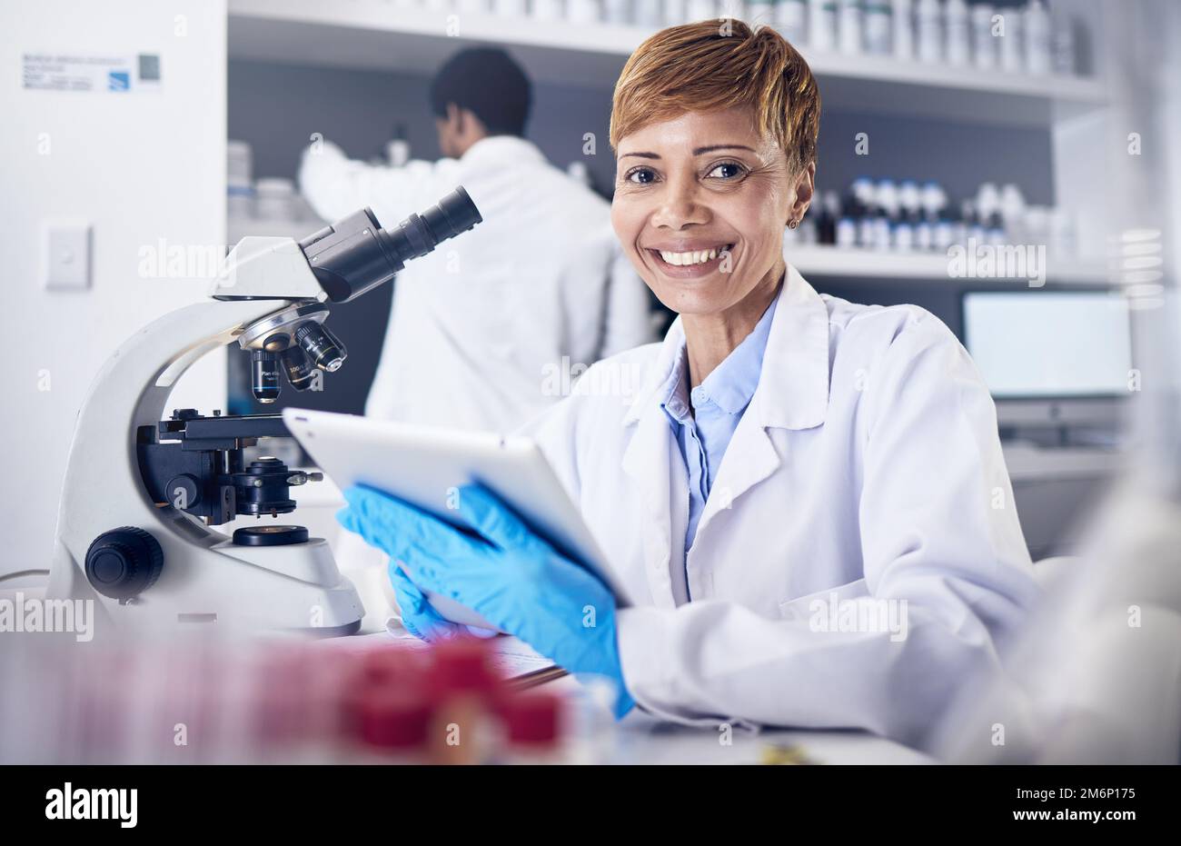 Science, tablet and woman in laboratory, research and healthcare with