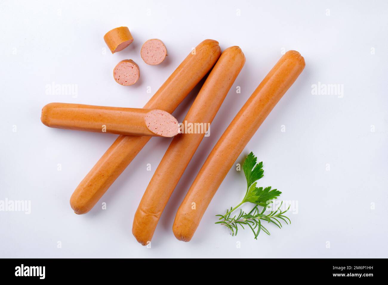 Traditional raw German Frankfurter sausage offered as top view on white