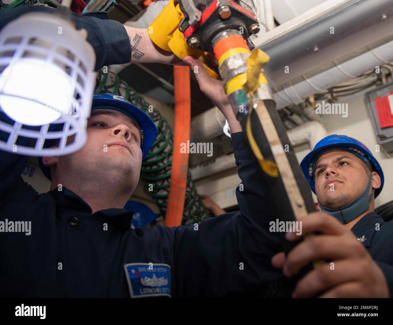 YOKOSUKA, Japan (May 03, 2022) - Logistics Specialist Seaman Christopher Ditto (left), from Smithville, Ark., and Information Systems Technician 3rd Class Hannibal Mendez, from Orlando, Fla., disconnect a piping system during an 8010 fire drill aboard U.S. 7th Fleet flagship USS Blue Ridge (LCC 19), May 3, 2022. The 8010 fire drill was created to train integrated teams of Sailors and base fire fighters to fight casualties in industrial environments. Blue Ridge is the oldest operational ship in the Navy and, as 7th Fleet command ship, actively works to foster relationships with allies and partn Stock Photo