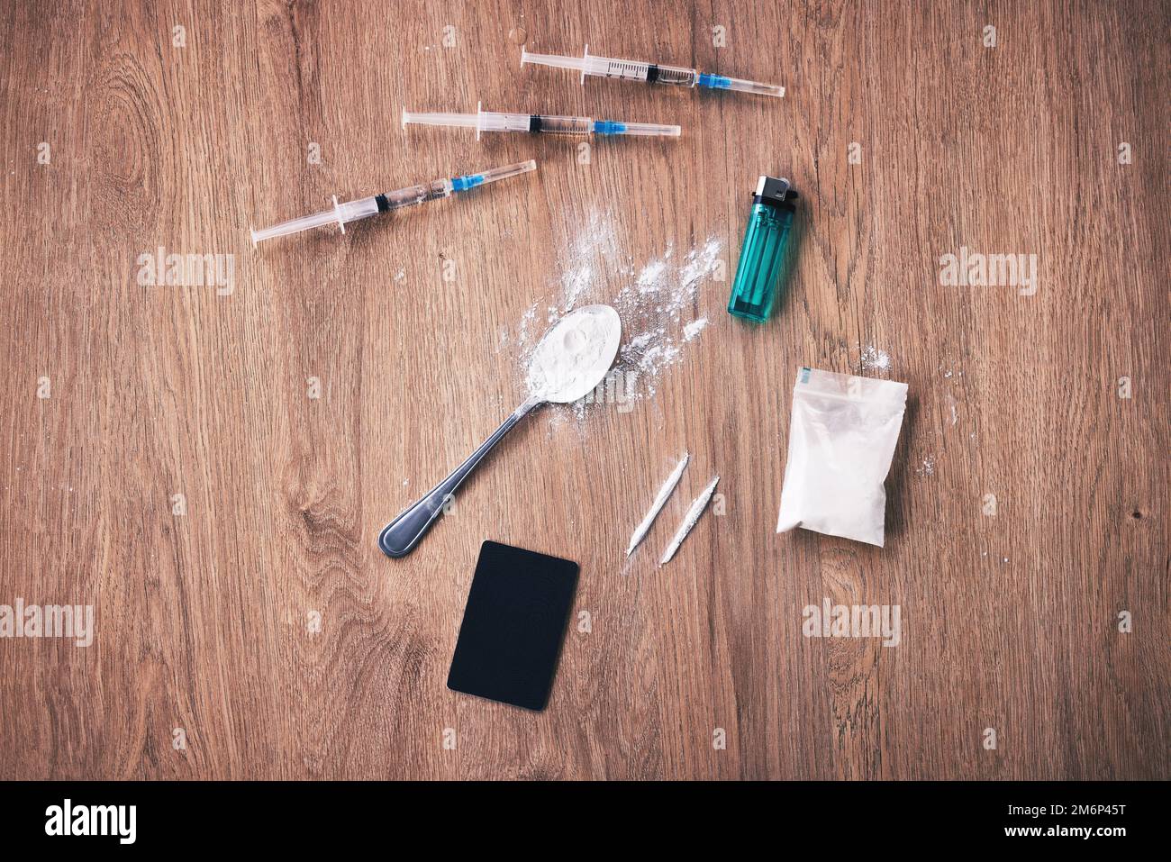 Powder, syringe and drugs with spoon on table for alcohol addiction