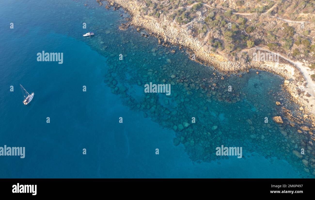 Drone aerial seascape with yacht moored in the coast. Summer vacations in the sea. Ayia Napa Cyprus Stock Photo