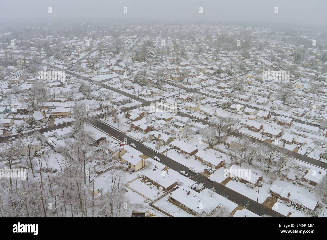 Spectacular aerial view of small American home town after snowfall