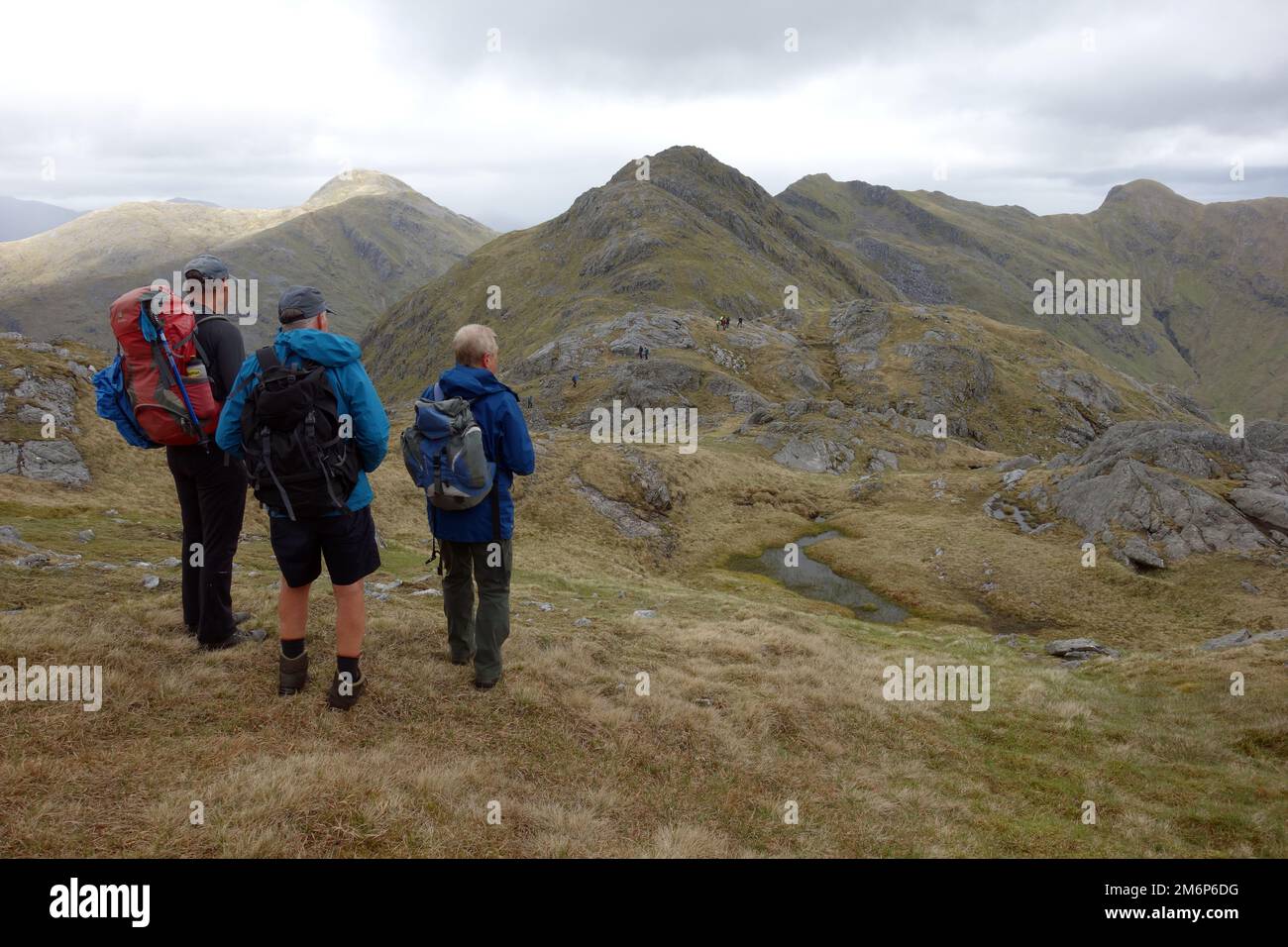 Three Men on 'Meall an Uillt Chaoil' Looking to the Scottish Mountain Corbett 'Streap' in Gleann Dubh Lighe near Glenfinnan, Scottish Highlands. Stock Photo