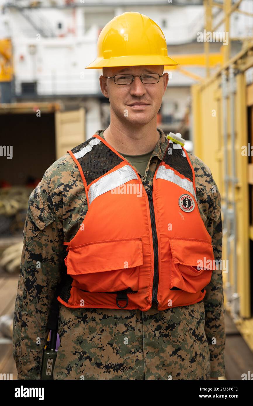 U.S. Marine Corps Staff Sgt. Ryan Multer, company GySgt with Bulk Fuel Company, 7th Engineer Support Battalion, 1st Marine Logistics Group, poses for a portrait during tactical bulk fuel operations aboard the Ocean Valor on May 3, 2022. Demonstrations of both existing and new bulk liquid distribution systems were utilized to aid development of fuel distribution in contested littoral environments. Stock Photo