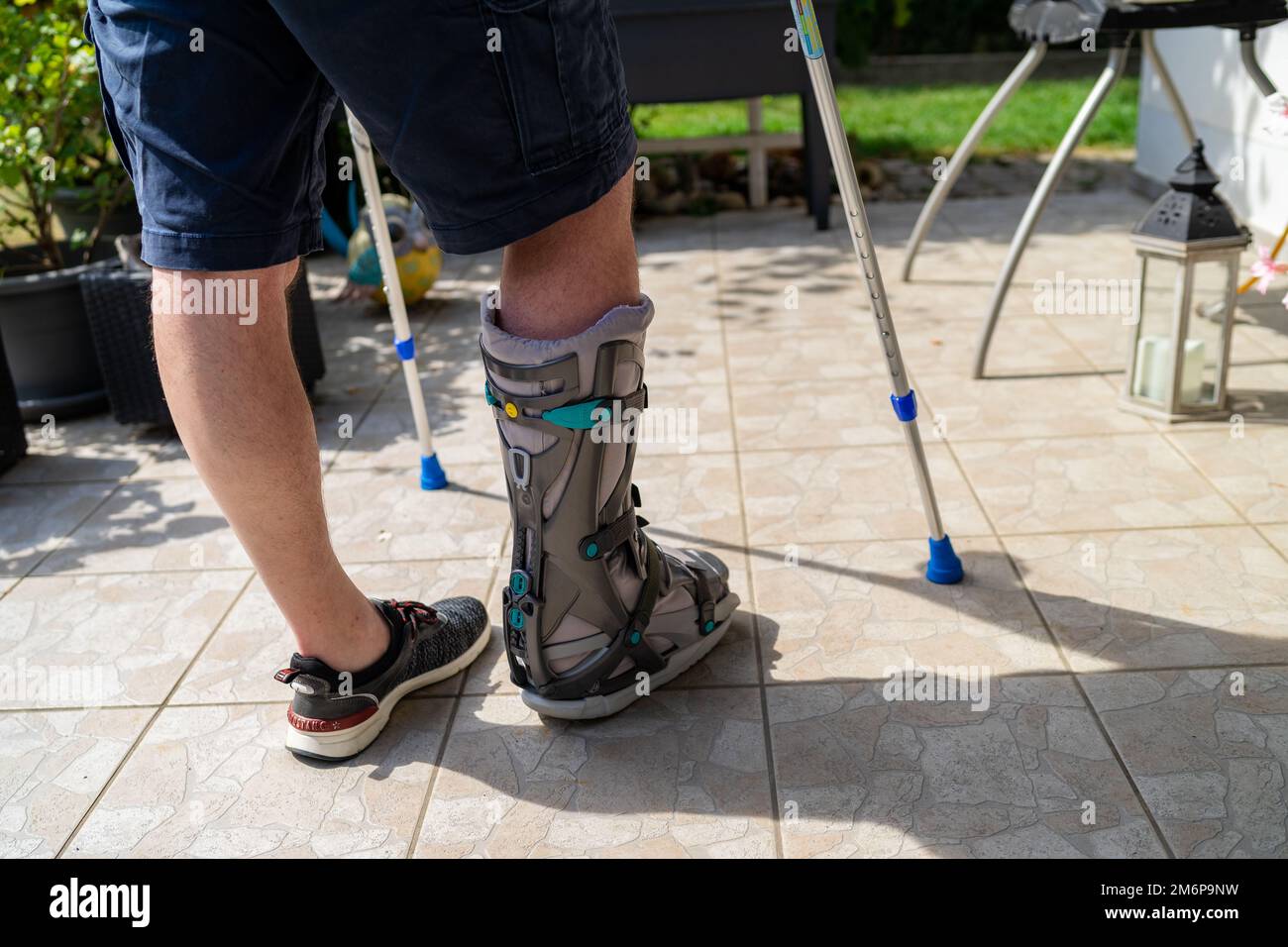 Broken Leg with Orthese and Crutches after Accident in Bavaria Germany. Stock Photo
