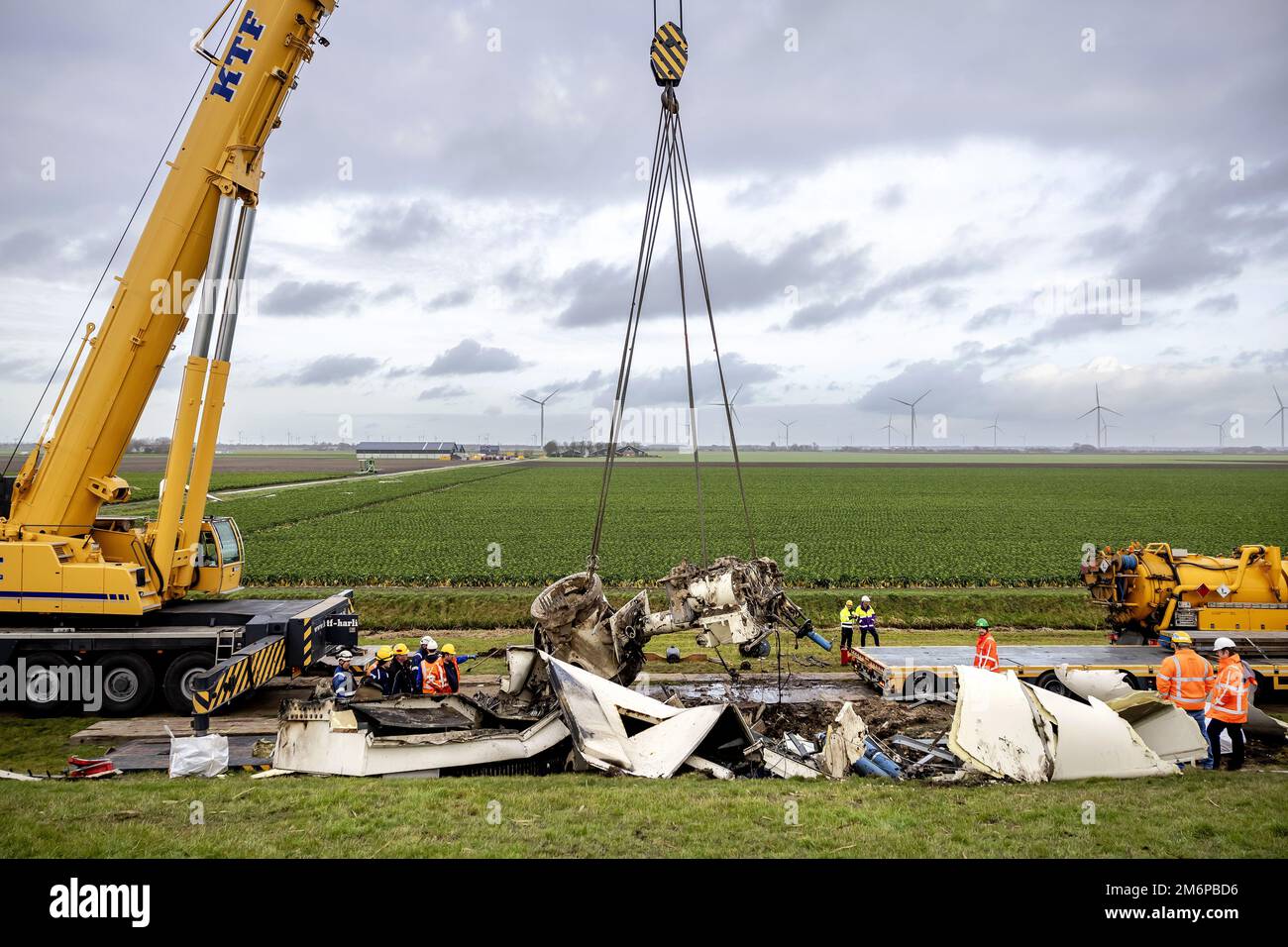 ZEEWOLDE - Work with a crane on the debris of the demolished windmill in Zeewolde. The wind turbine was an older model and stopped after an error message. The wind was blowing hard, but it is not yet clear whether the windmill has broken as a result. ANP ROBIN VAN LONKHUIJSEN netherlands out - belgium out Stock Photo