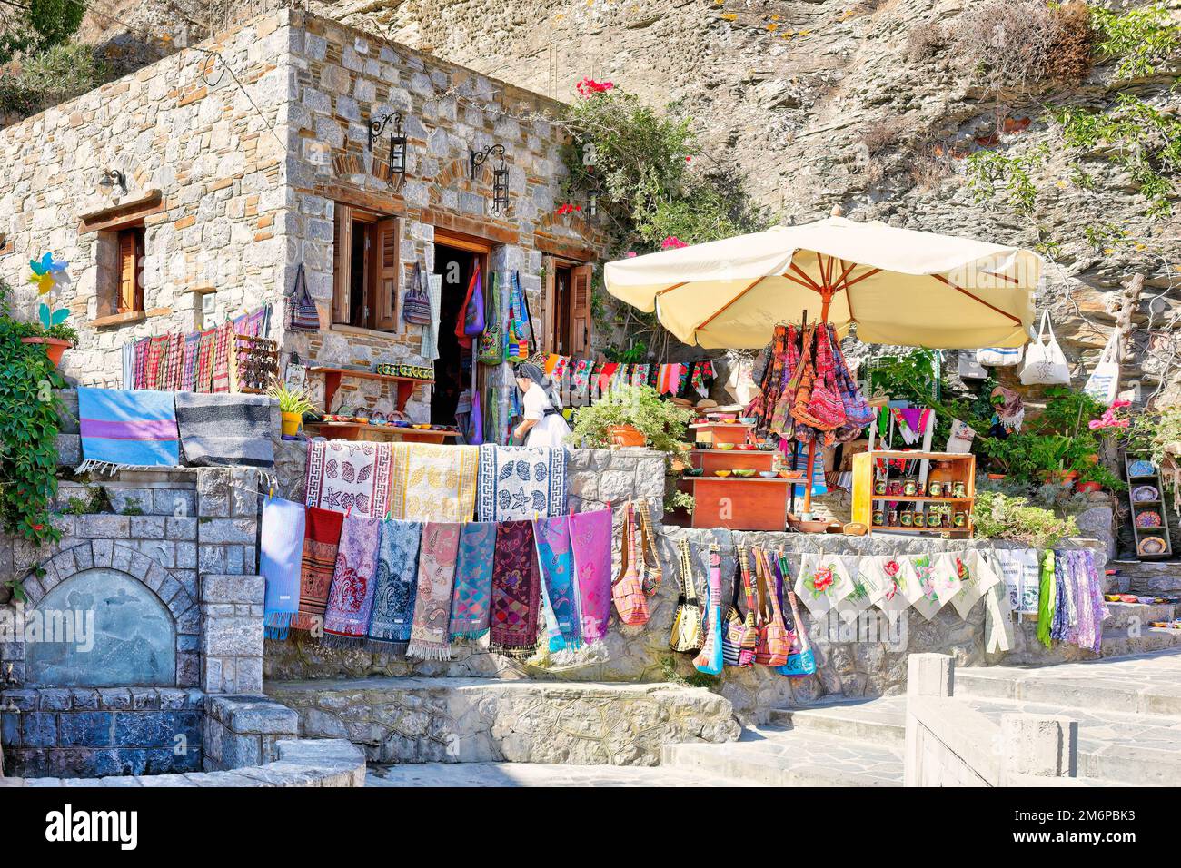 An old woman selling traditional handcrafts at the village Olympos in Karpathos, Greece Stock Photo