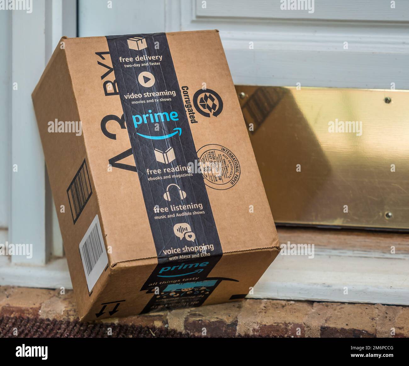 Amazon prime box delivered to residential doorstep. Amazon offers free package delivery to it's prime members. Stock Photo
