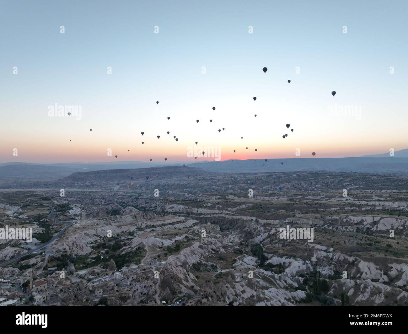 Aerial cinematic drone view of colorful hot air balloon flying over ...