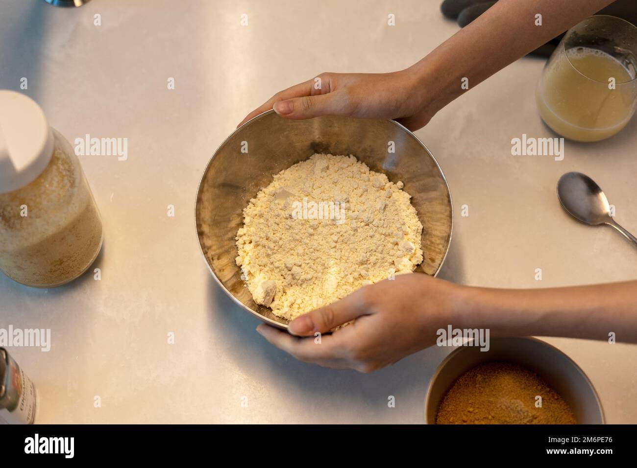 Making cookie bread dough before baking, hands holding bowl of flour