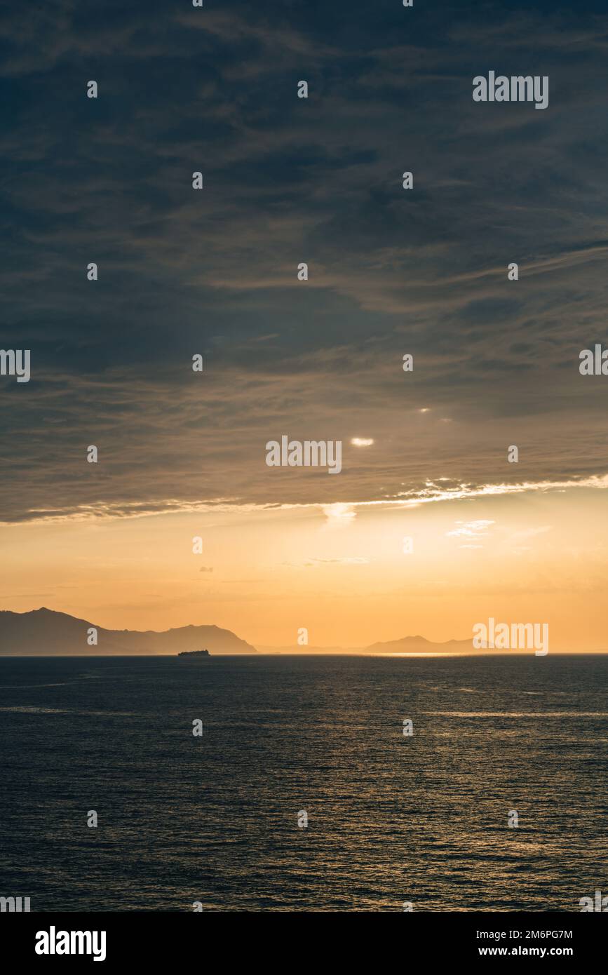 Sunset over the sea with a Cruise Ship on sea Stock Photo - Alamy