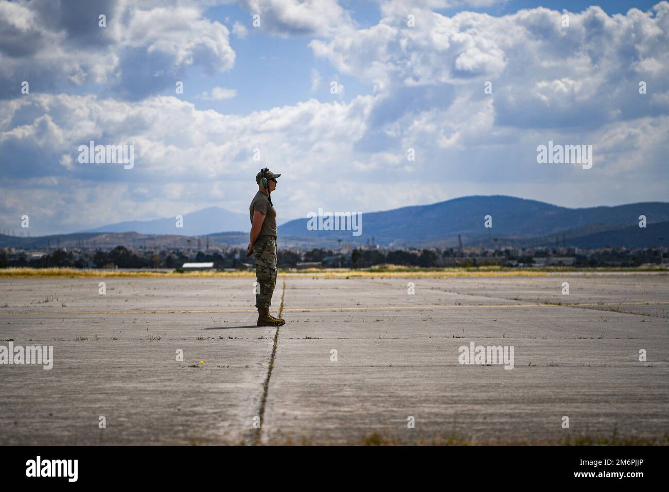 U.S. Air Force Staff Sgt. John Dockery, 86th Aircraft Maintenance Squadron flying crew chief, prepares to guide a U.S. Air Force C-130J Super Hercules aircraft during Exercise Stolen Cerberus IX at Elefsina Air Base, Greece, May 11, 2022. Airmen from the 86th Airlift Wing, Ramstein Air Base, Germany, and personnel assigned to the 435th Air Ground Operations Wing. Stock Photo