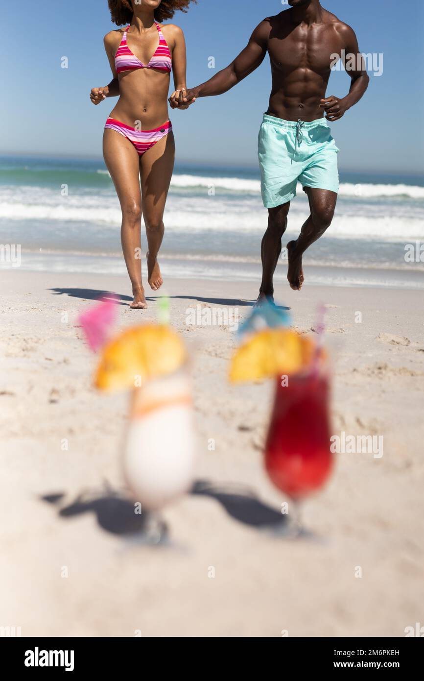 Black couple enjoying beach together hi-res stock photography and