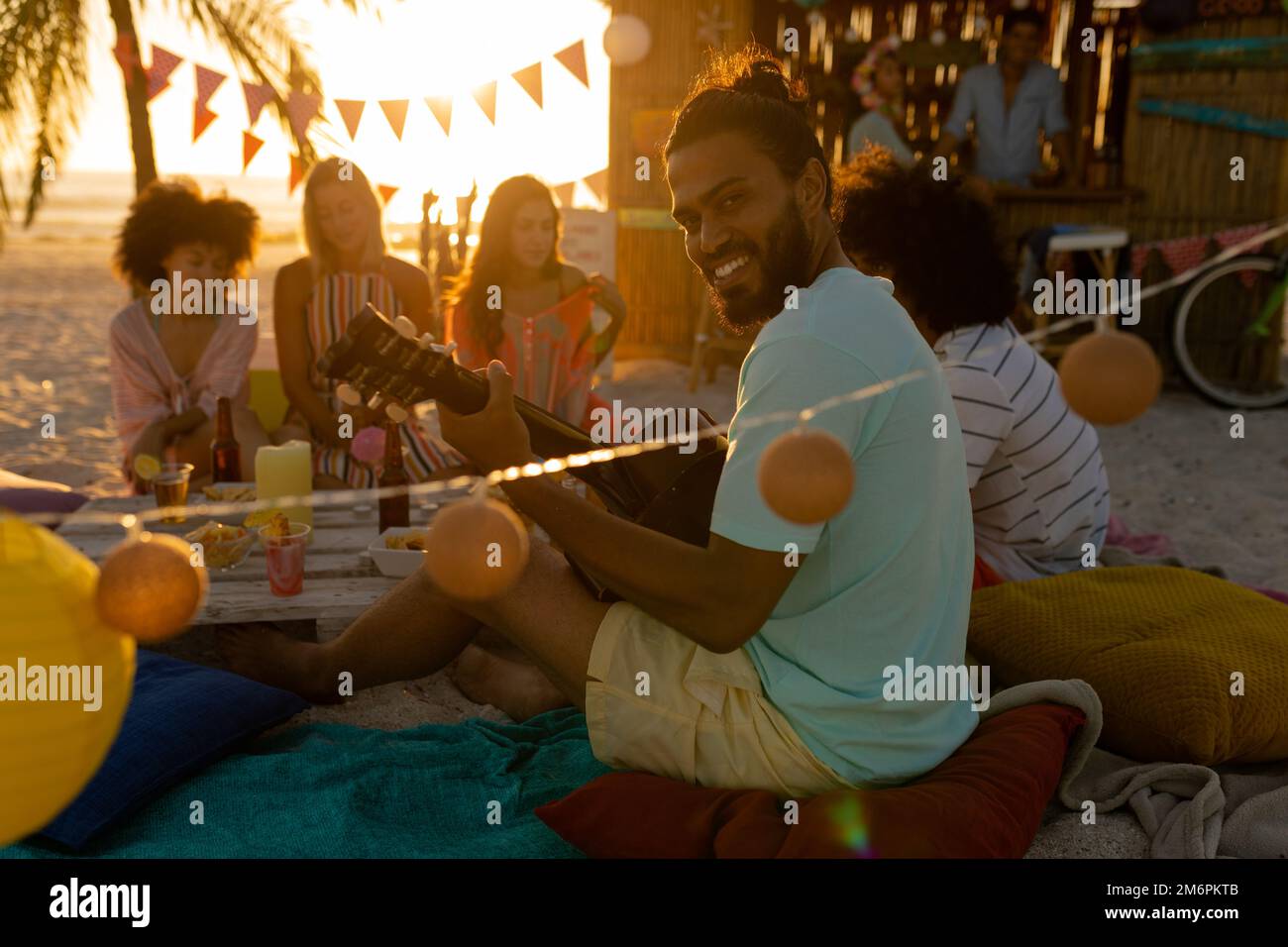 Mixed race friends group having fun on beach Stock Photo - Alamy
