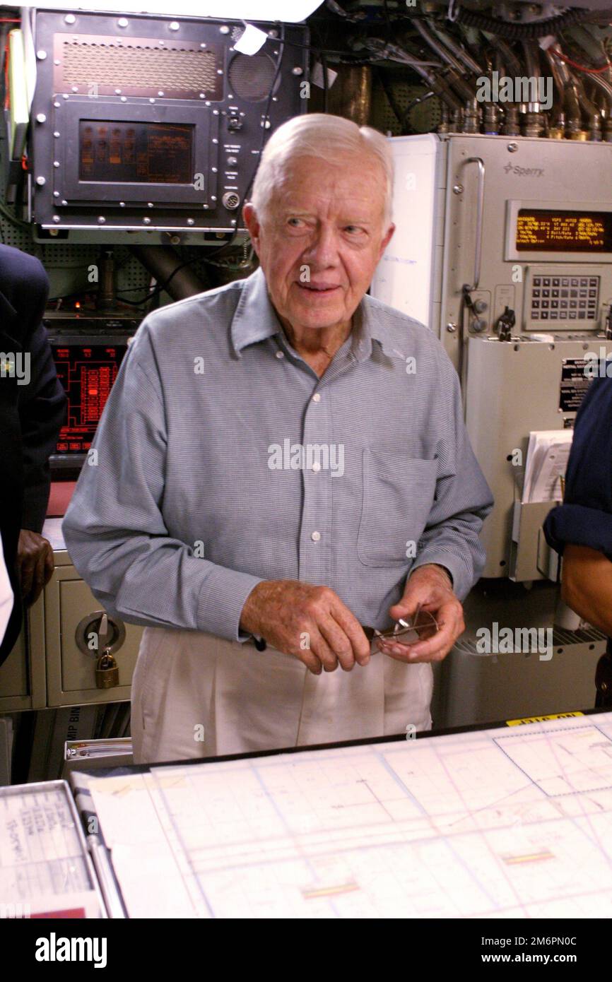 Kings Bay, Ga. (Aug. 11, 2005) - Former President Jimmy Carter looks over the navigation table in the control room of his namesake ship, the Sea Wolf-class attack submarine USS Jimmy Carter (SSN 23). Carter and his wife Rosalynn, spent the night aboard the submarine, touring the ship and meeting with crew members. USS Jimmy Carter is the third Sea Wolf-class attack submarine. U.S. Navy photo by Lt. Mark Jones Stock Photo