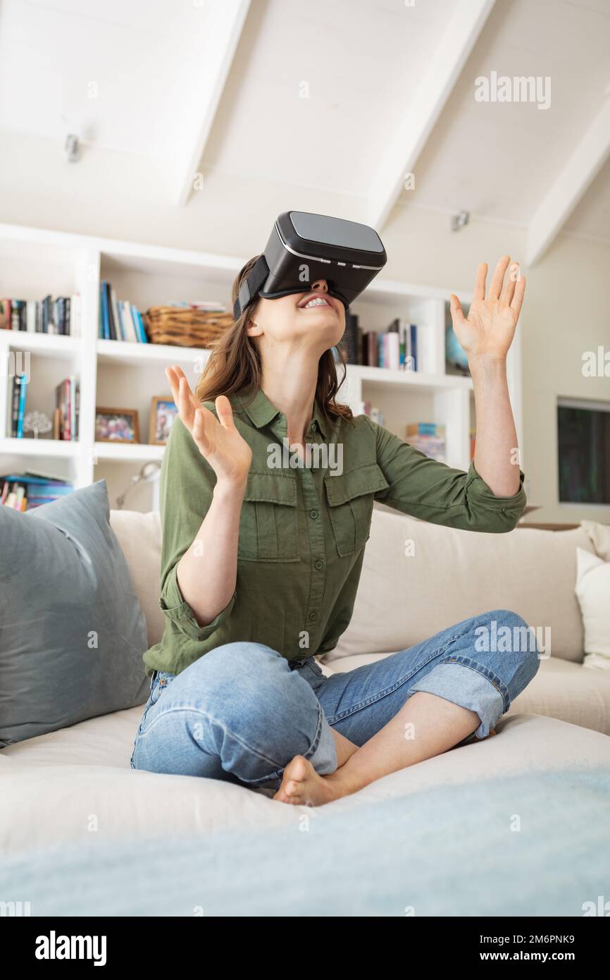 Woman using Virtual Reality Headset at home Stock Photo - Alamy