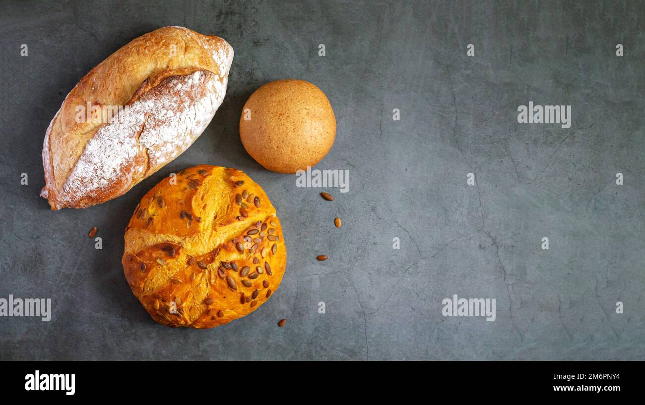 Bakery background with set of different freshly baked crispy bread on ...