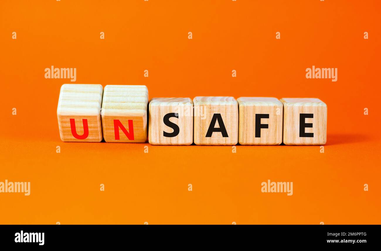 Safe or unsafe symbol. Concept word Safe Unsafe on wooden cubes