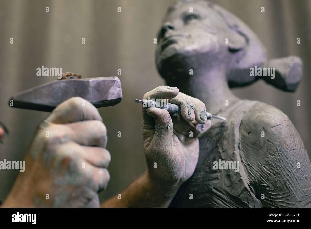 Man sculptor creates sculpt bust human woman sculpture. Statue craft