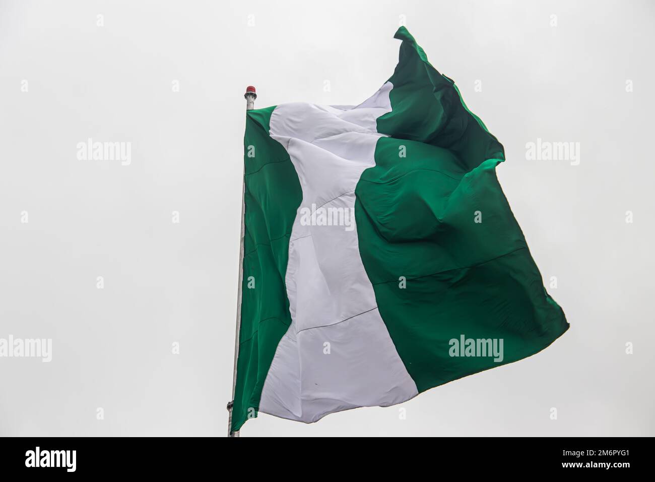 Nigerian flag, with three vertical bands of green, white, green. The