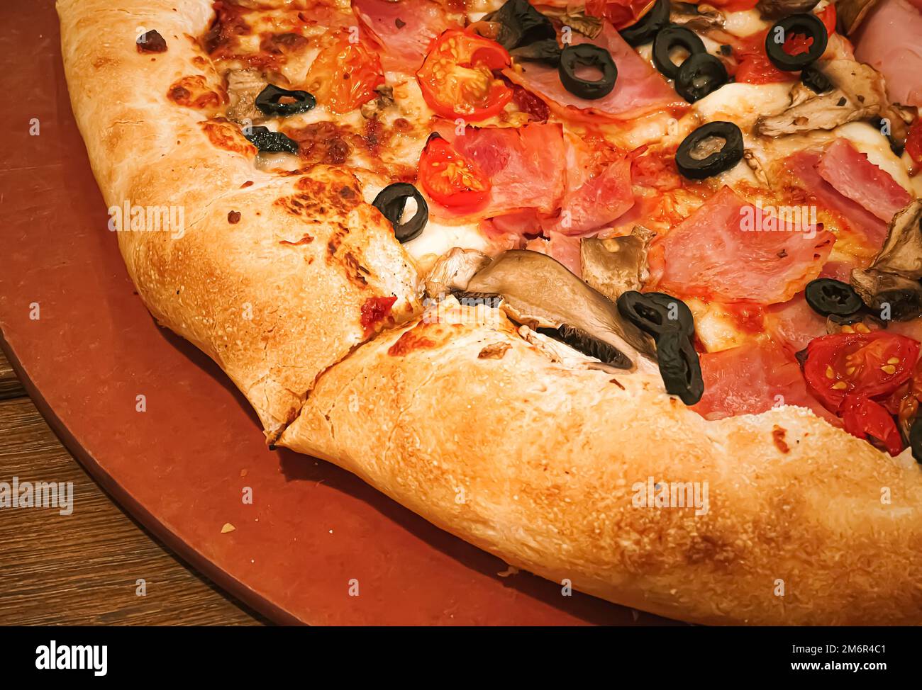 Pizza capriciosa with cheese stuffed crust in pizzeria, food Stock Photo