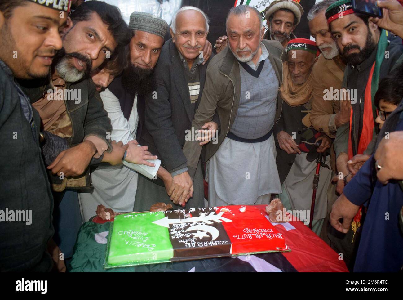 Leaders and activists of Peoples Party (PPP) are cutting cake as they are marking 95th Birthday Anniversary of Zulfiqar Ali Bhutto, during celebration ceremony held in Peshawar on Thursday, January 05, 2023. Stock Photo