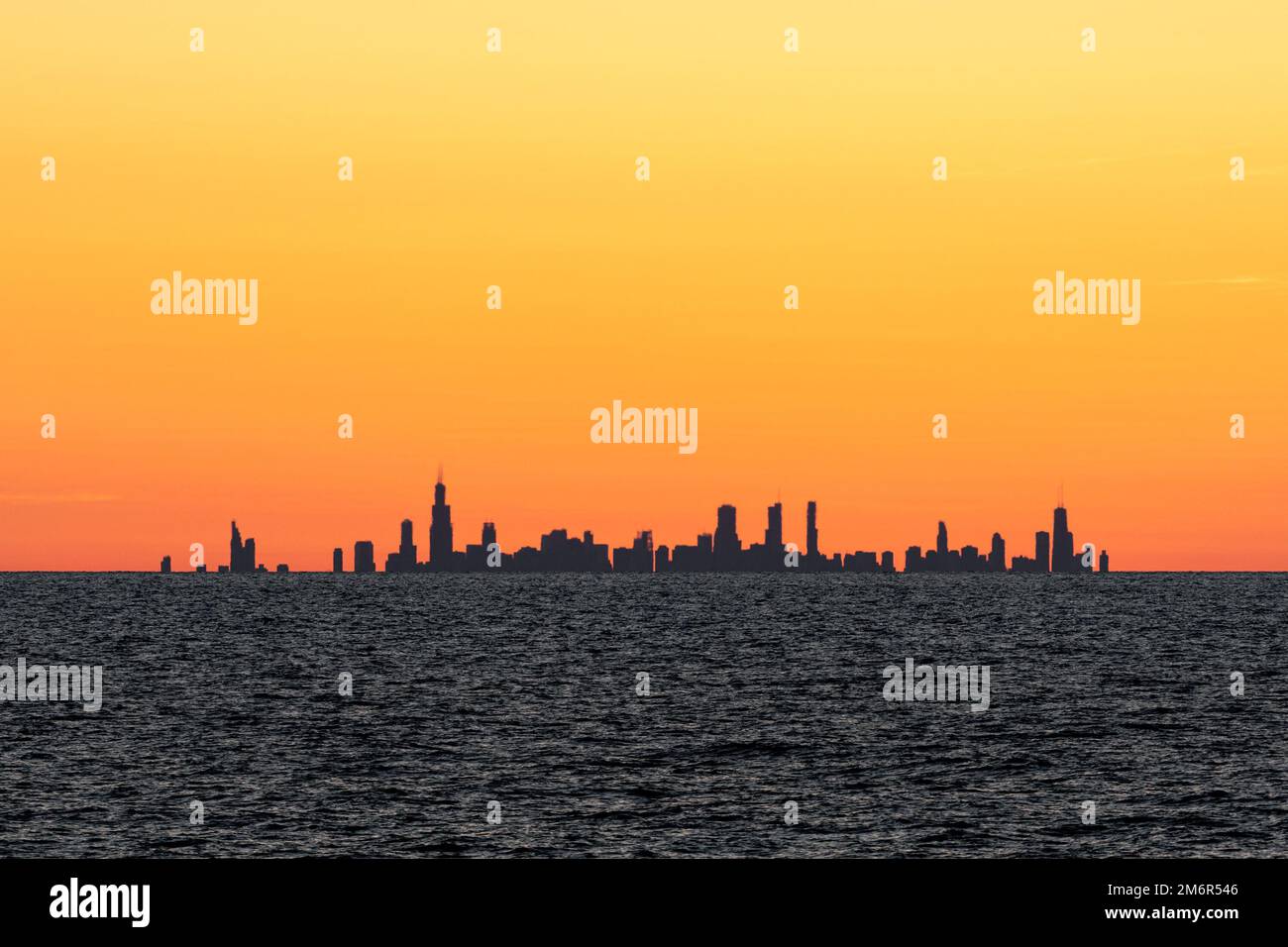 Chicago skyline sunset, seen from across Lake Michigan in the neighbouring state of Indiana, USA, 35 miles away from The Loop. Stock Photo